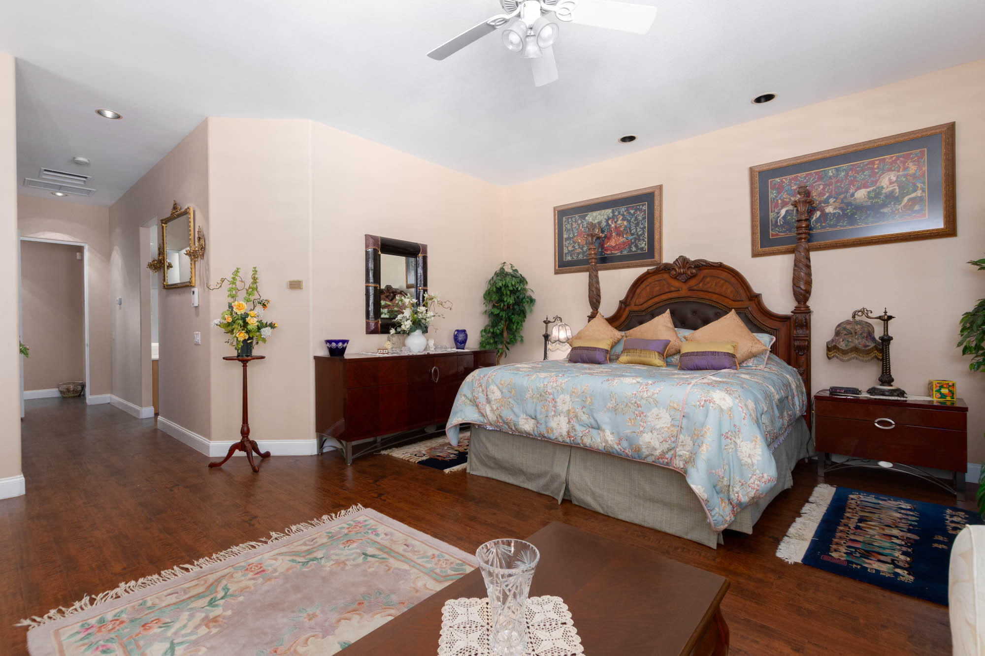 4 Bentley Road Rancho Mirage, CA 92270 - Photo 8 of 13 a bedroom with a bed and dresser with mirror