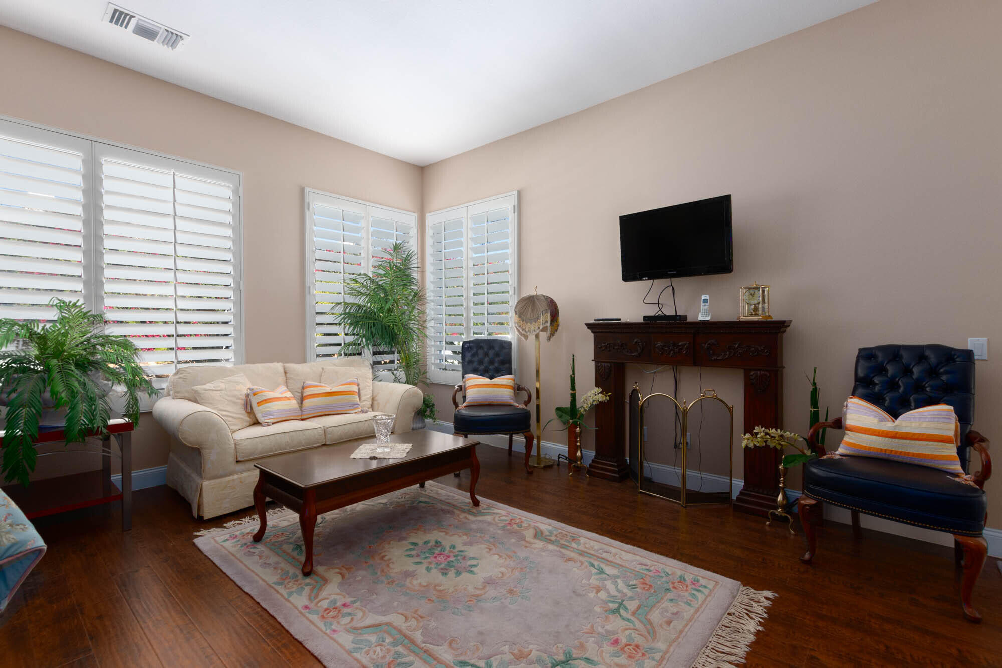 4 Bentley Road Rancho Mirage, CA 92270 - Photo 9 of 13 a living room with furniture a flat screen tv and a fireplace
