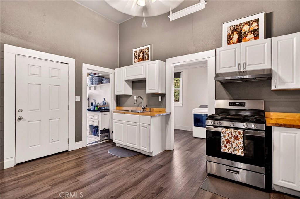 1214 Marin Street Corning, CA 96021 - Photo 12 of 57 a kitchen with stainless steel appliances a stove a microwave and cabinets