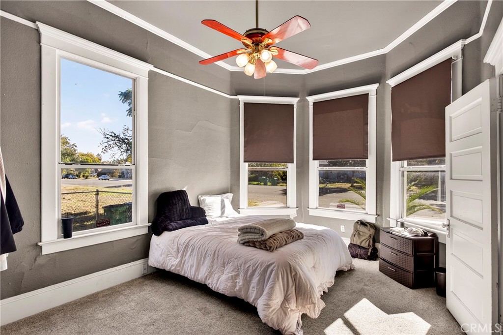 1214 Marin Street Corning, CA 96021 - Photo 21 of 57 a bedroom with a large bed and a large window with outer view