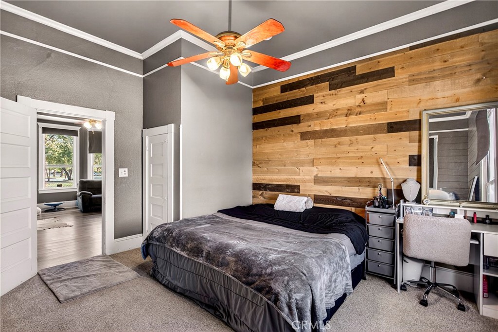 1214 Marin Street Corning, CA 96021 - Photo 22 of 57 a bedroom with a bed and a chandelier