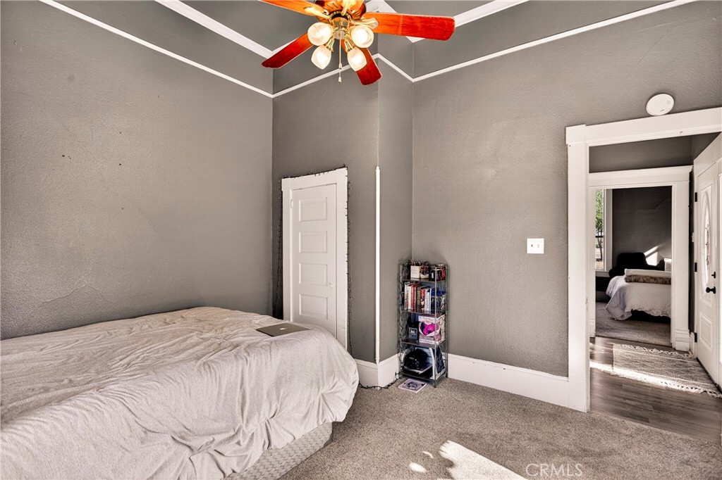 1214 Marin Street Corning, CA 96021 - Photo 26 of 57 a bedroom with a bed and a chandelier