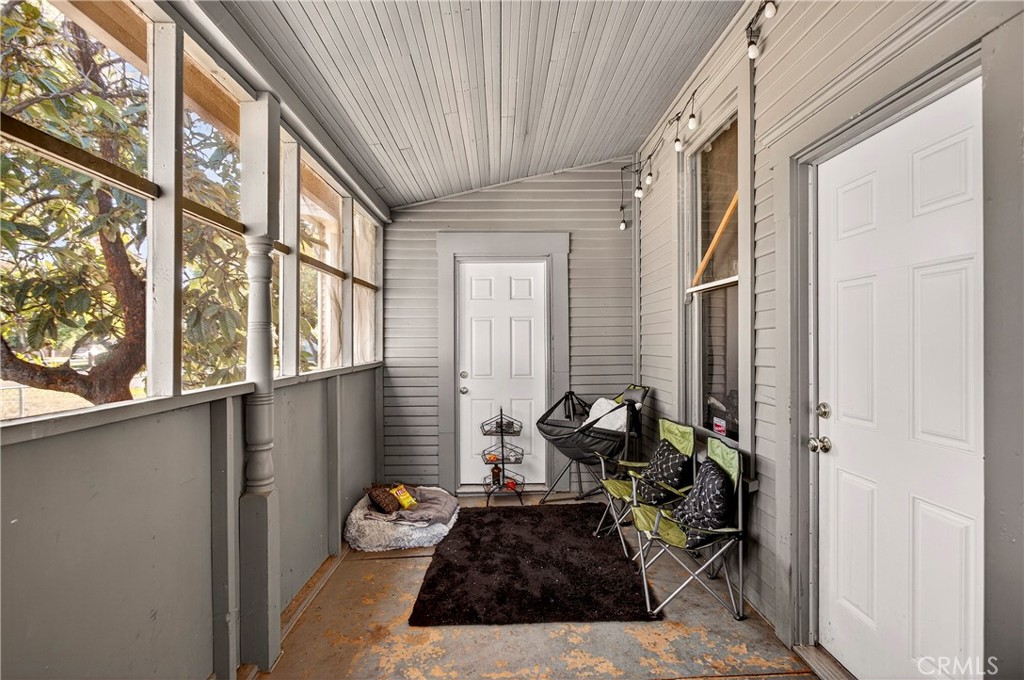 1214 Marin Street Corning, CA 96021 - Photo 37 of 57 a living room with furniture and a floor to ceiling window