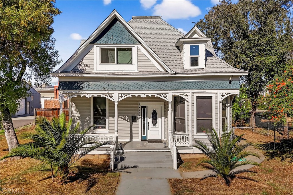 1214 Marin Street Corning, CA 96021 - Photo 4 of 57 a view of a house with large windows and a tree