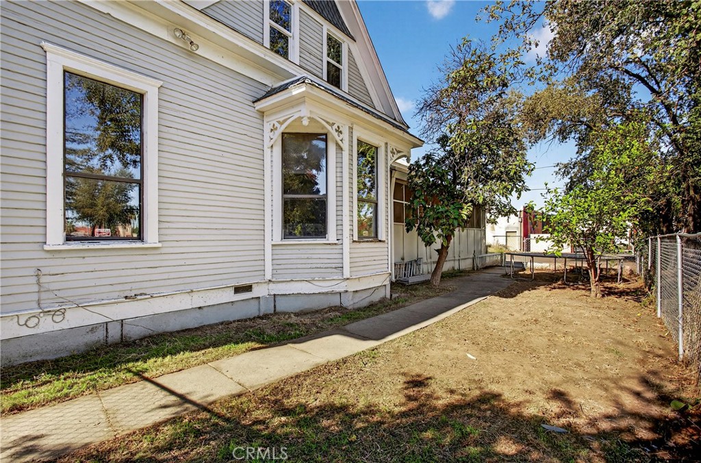 1214 Marin Street Corning, CA 96021 - Photo 42 of 57 a yellow house with trees in front of it