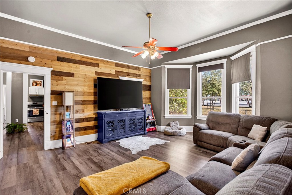 1214 Marin Street Corning, CA 96021 - Photo 10 of 57 a living room with furniture a flat screen tv and a large window