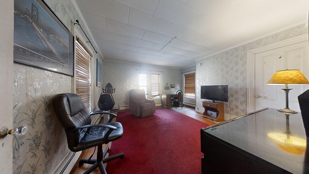 57 Church Street Watertown, MA 02472 - Photo 12 of 18 a living room with furniture a flat screen tv and a fireplace