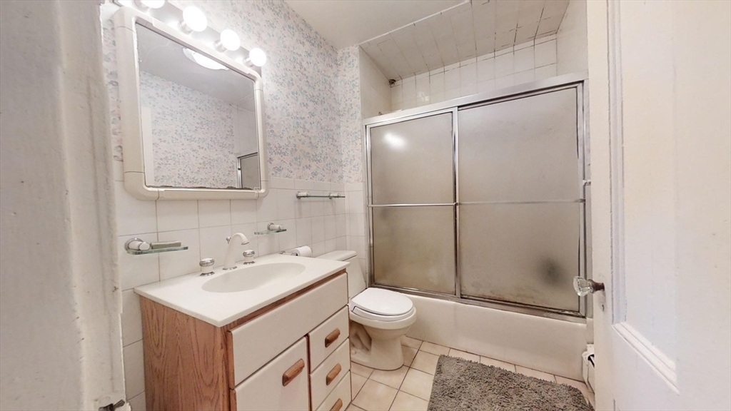 57 Church Street Watertown, MA 02472 - Photo 14 of 18 a bathroom with a sink toilet and shower