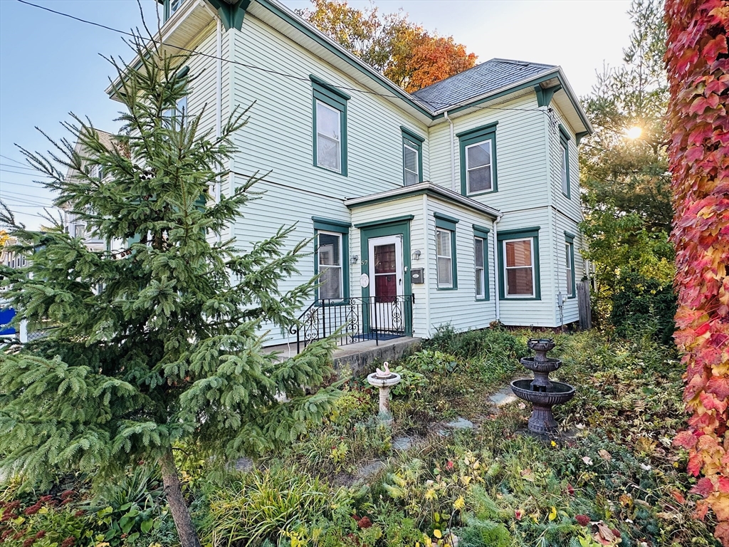 57 Church Street Watertown, MA 02472 - Photo 17 of 18 front view of a house with a small yard