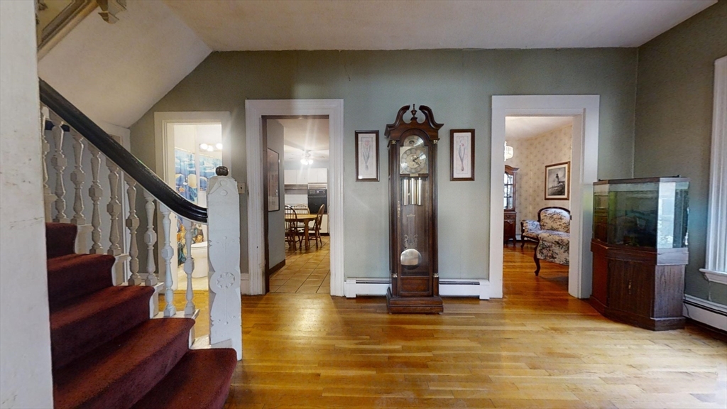 57 Church Street Watertown, MA 02472 - Photo 2 of 18 a view of an entryway with wooden floor and a livingroom
