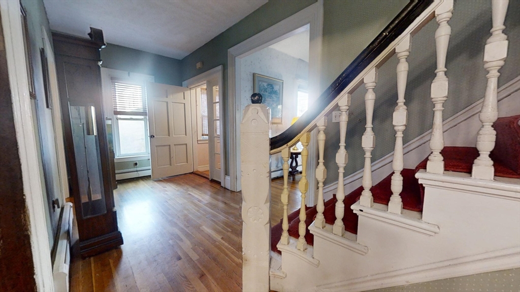 57 Church Street Watertown, MA 02472 - Photo 3 of 18 a view of entryway with wooden floor and stairs