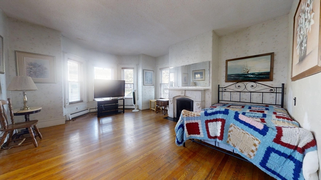 57 Church Street Watertown, MA 02472 - Photo 4 of 18 a living room with furniture and a flat screen tv