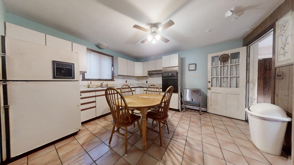 57 Church Street Watertown, MA 02472 - Photo 6 of 18 a view of a dining room with furniture and a chandelier