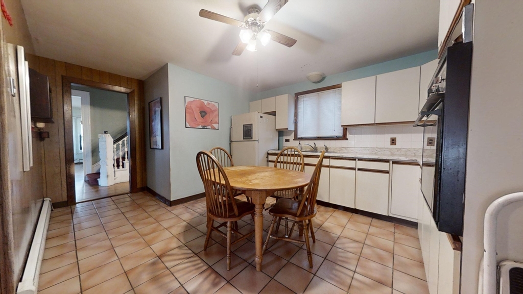57 Church Street Watertown, MA 02472 - Photo 7 of 18 a kitchen with stainless steel appliances granite countertop a sink a stove a refrigerator dining table and chairs