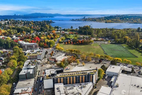 an aerial view of residential building and lake