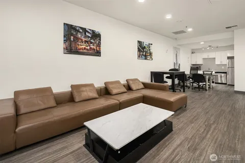 a dining room with furniture and wooden floor