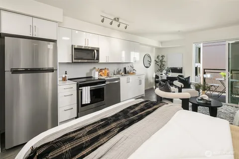 a kitchen with a refrigerator and a stove top oven