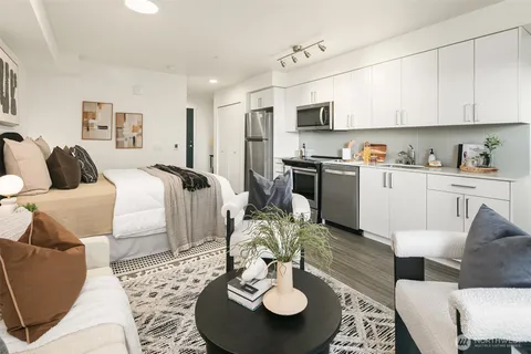 a living room with furniture kitchen and a dining table