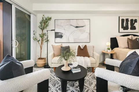 a living room with furniture and a potted plant