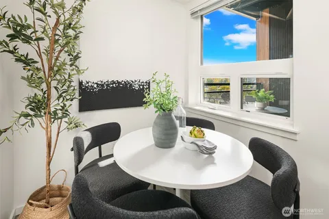 a dining room with furniture and wooden floor
