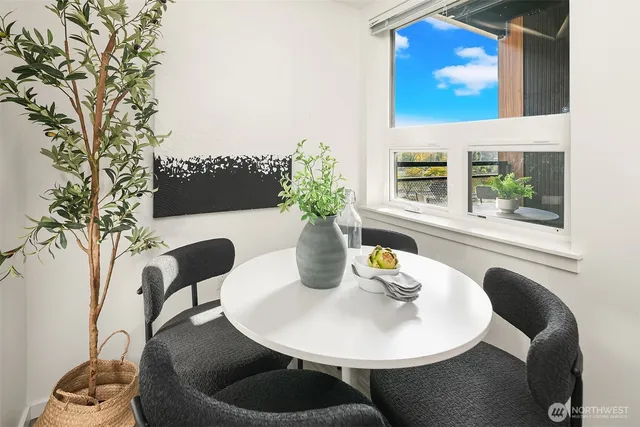 a dining room with furniture and wooden floor