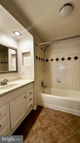a spacious bathroom with a tub sink shower and mirror
