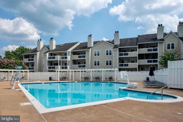 a view of a house with swimming pool and sitting area