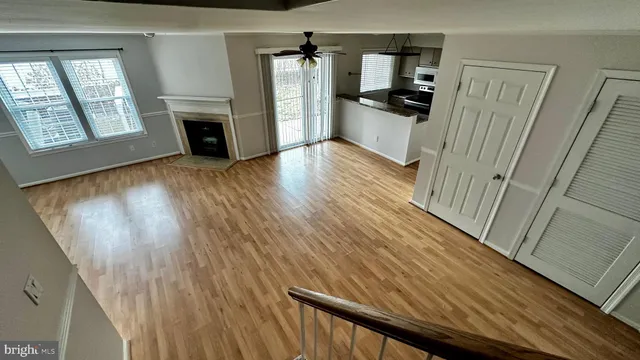 a view of a hallway view with wooden floor and staircase