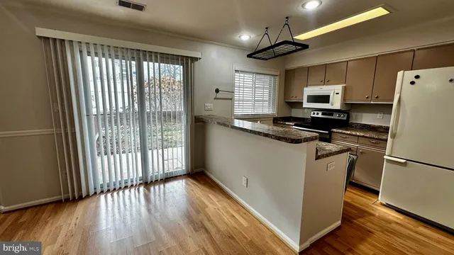 a kitchen with stainless steel appliances a refrigerator sink and microwave