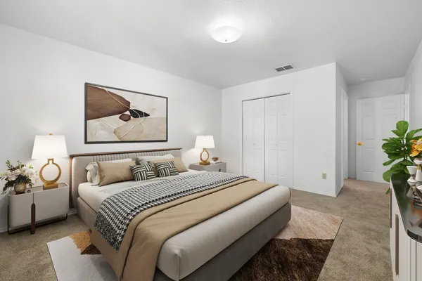 a bedroom with a bed and a painting on the wall