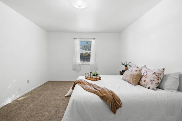 a bedroom with a bed and a window