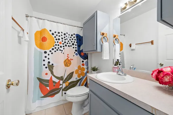 a bathroom with a sink mirror and vanity