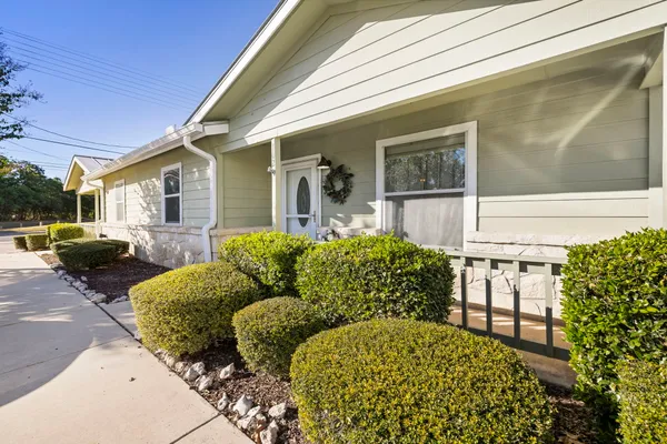 a view of a house with backyard and sitting area