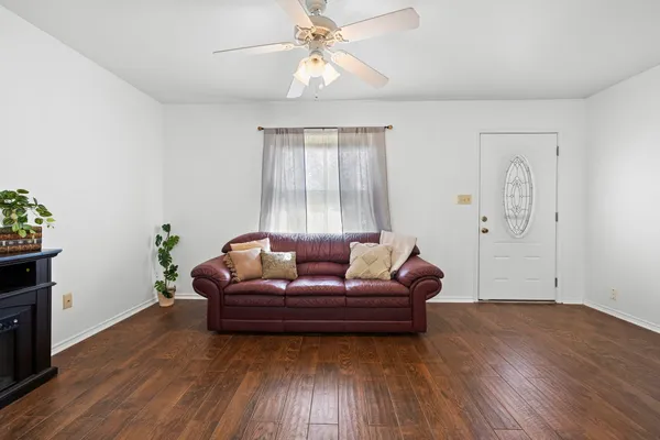 a living room with furniture and wooden floor