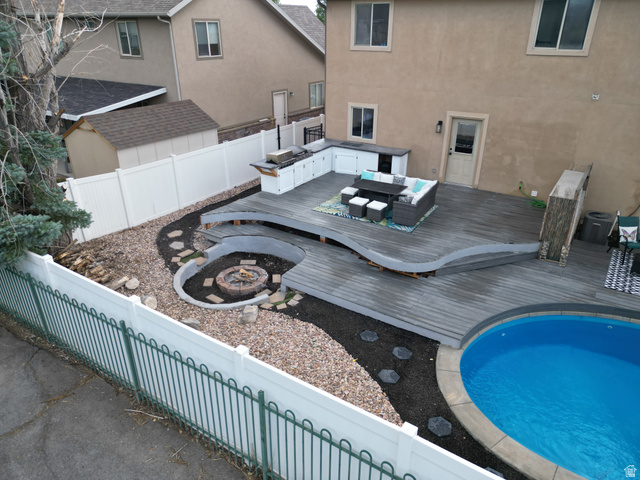1585 South 910 West Payson, UT 84651 - Photo 30 of 32 Expansive backyard featuring a multi-level deck, built-in outdoor kitchen, recessed fire pit, and a circular swimming pool