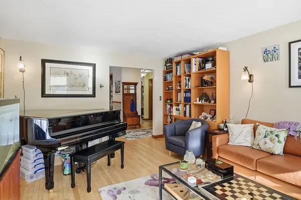 a living room with furniture a rug and a bookshelf
