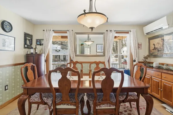 a view of a dining room with furniture and chandelier