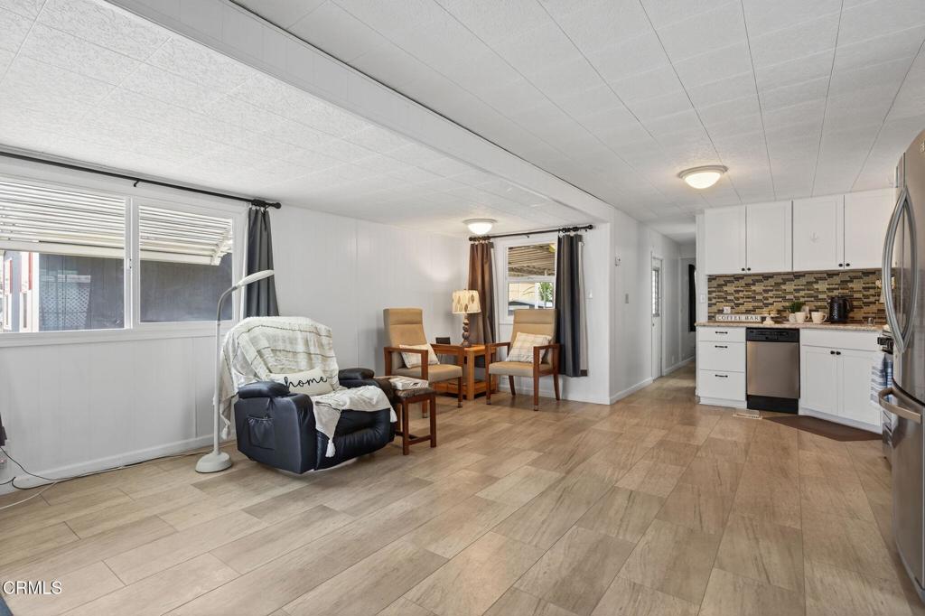4032 Mockingbird Lane, Unit 4032 Oxnard, CA 93033 - Photo 11 of 36 a living room with furniture and kitchen view