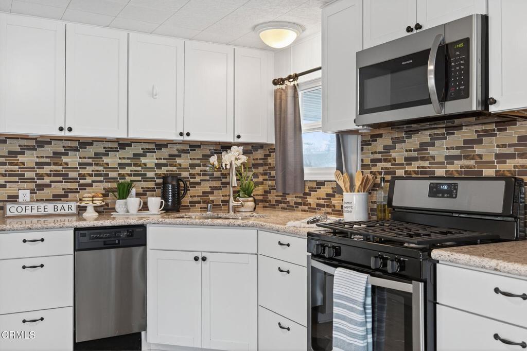 4032 Mockingbird Lane, Unit 4032 Oxnard, CA 93033 - Photo 20 of 36 a kitchen with stainless steel appliances a stove a sink and a microwave