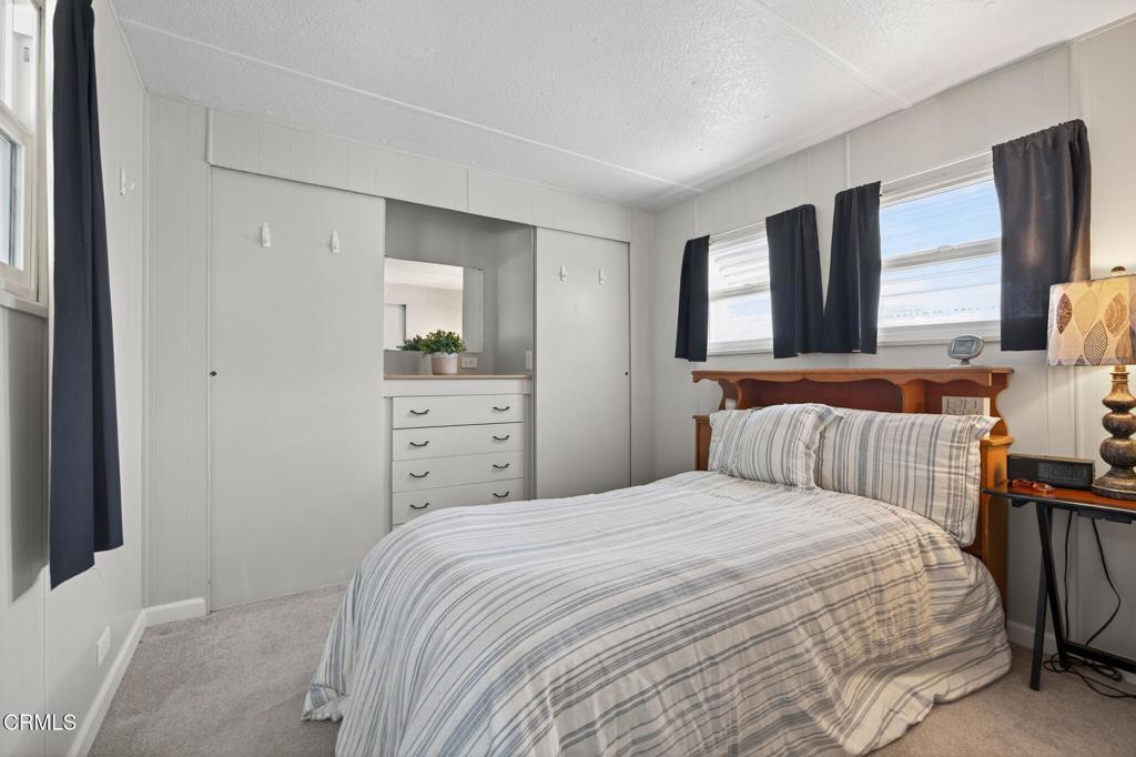 4032 Mockingbird Lane, Unit 4032 Oxnard, CA 93033 - Photo 22 of 36 a bedroom with a bed and a window