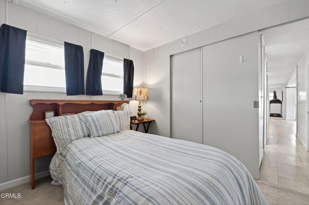 4032 Mockingbird Lane, Unit 4032 Oxnard, CA 93033 - Photo 23 of 36 a bedroom with a large bed and a closet