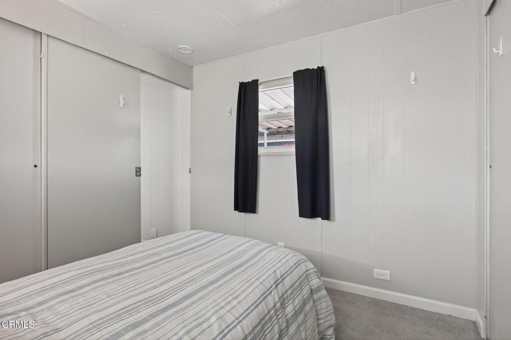4032 Mockingbird Lane, Unit 4032 Oxnard, CA 93033 - Photo 24 of 36 a bedroom with a bed and a window