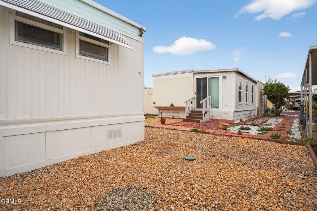 4032 Mockingbird Lane, Unit 4032 Oxnard, CA 93033 - Photo 27 of 36 a view of a porch with a table and chairs