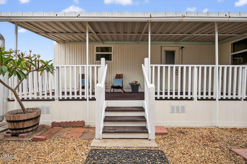 4032 Mockingbird Lane, Unit 4032 Oxnard, CA 93033 - Photo 30 of 36 a view of a patio with a table and chairs