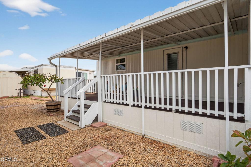 4032 Mockingbird Lane, Unit 4032 Oxnard, CA 93033 - Photo 31 of 36 a view of a chair and table in the back yard of the house