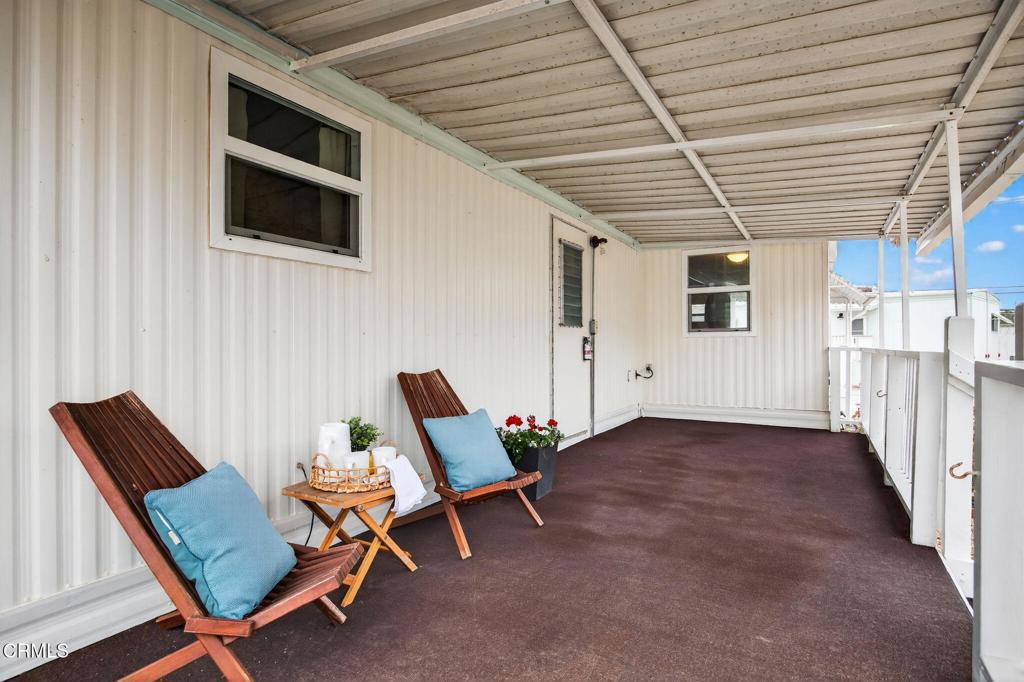 4032 Mockingbird Lane, Unit 4032 Oxnard, CA 93033 - Photo 33 of 36 a view of a patio with a table and chairs