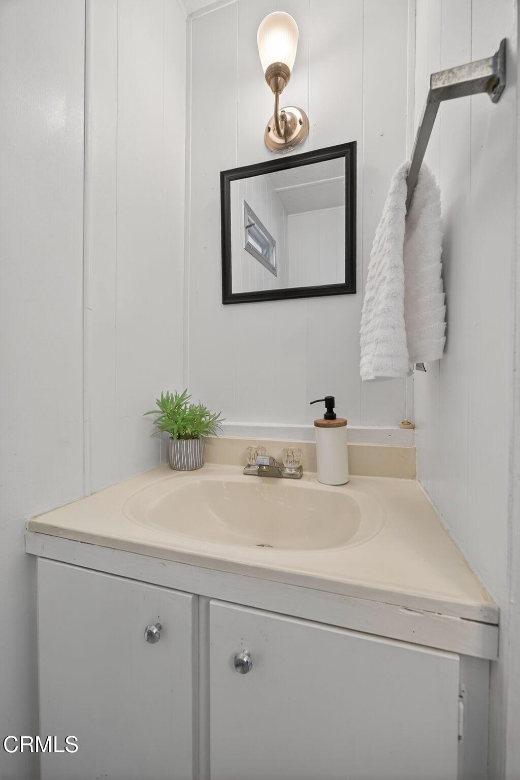 4032 Mockingbird Lane, Unit 4032 Oxnard, CA 93033 - Photo 9 of 36 a bathroom with a sink and a mirror