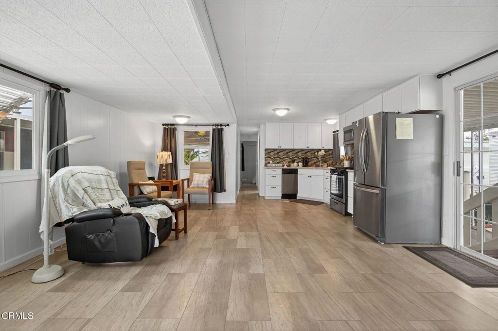 4032 Mockingbird Lane, Unit 4032 Oxnard, CA 93033 - Photo 10 of 36 a living room with furniture and a refrigerator