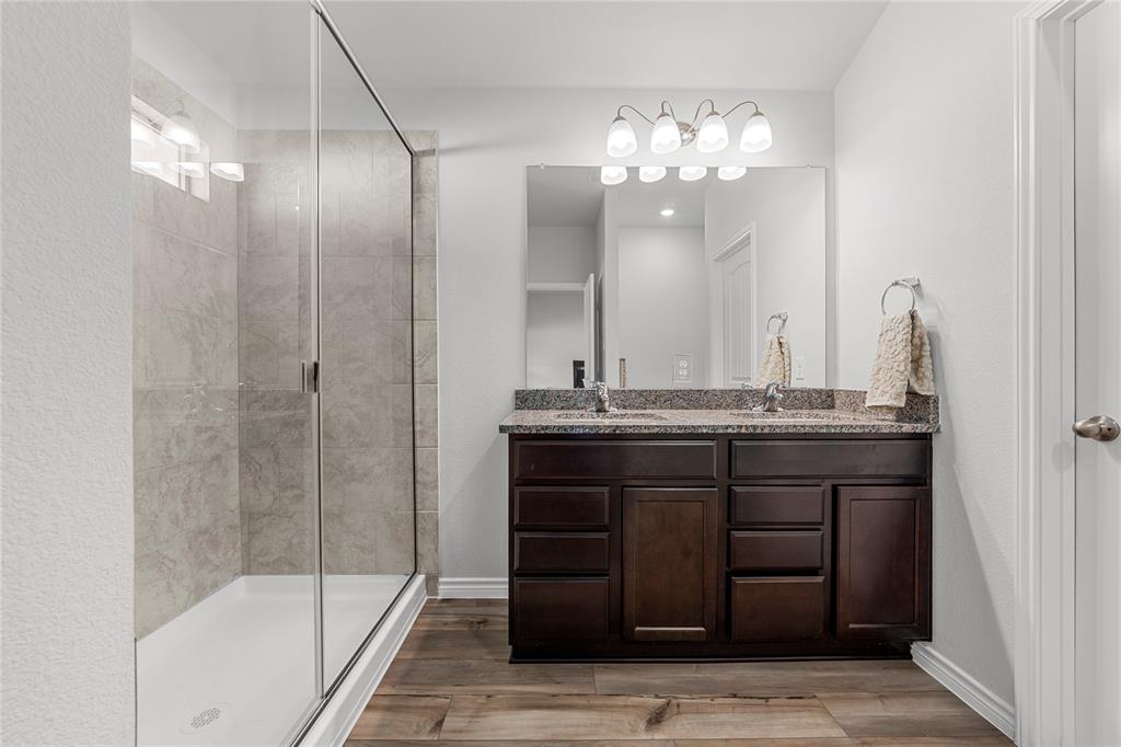 10761 Chesson Flts Drive Waco, TX 76708 - Photo 24 of 30 a bathroom with a granite countertop sink a mirror and shower