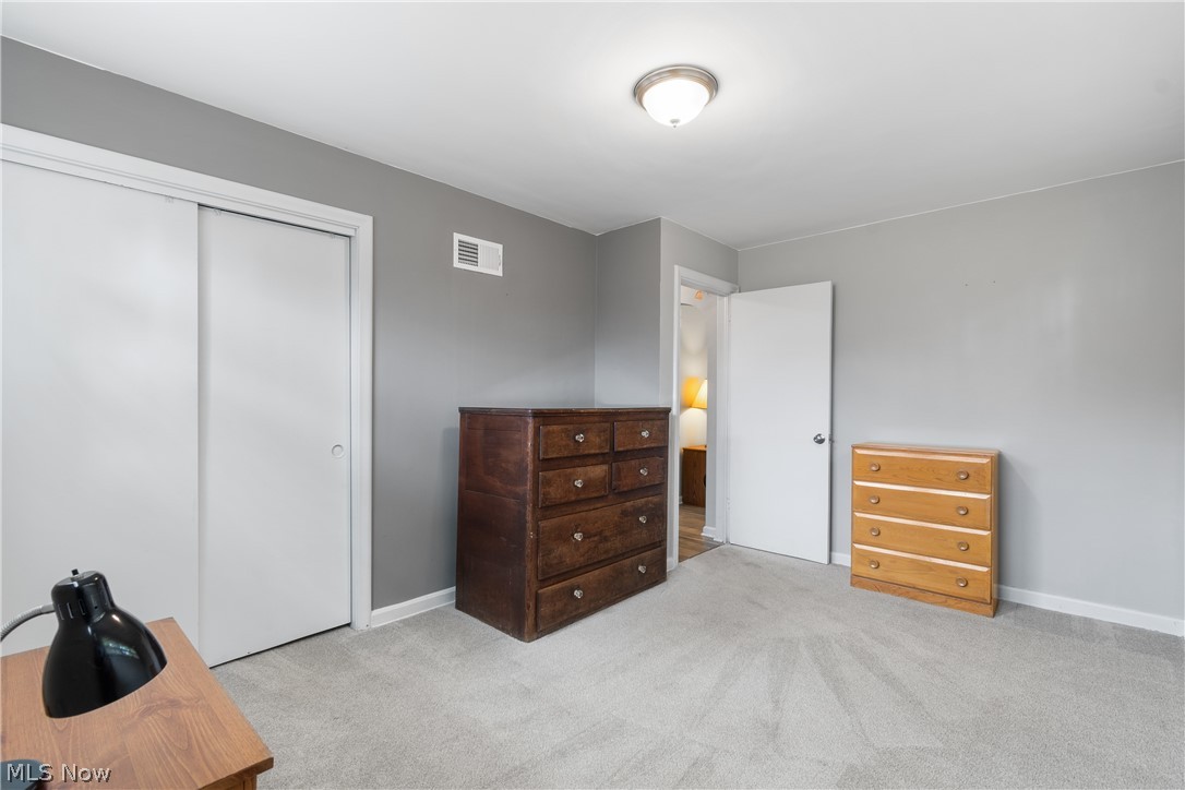 5768 Nolley Road Akron, OH 44319 - Photo 16 of 38 Carpeted room featuring light gray wall paint, white trim, and a white sliding closet door